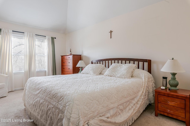 carpeted bedroom featuring lofted ceiling