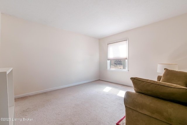 unfurnished room with carpet and baseboards