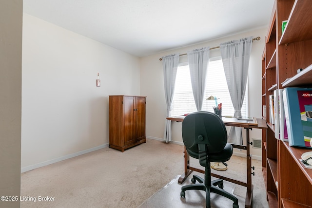 office space with light carpet, visible vents, and baseboards