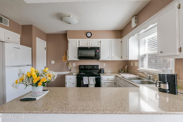 kitchen featuring a textured ceiling, black appliances, a sink, and white cabinets