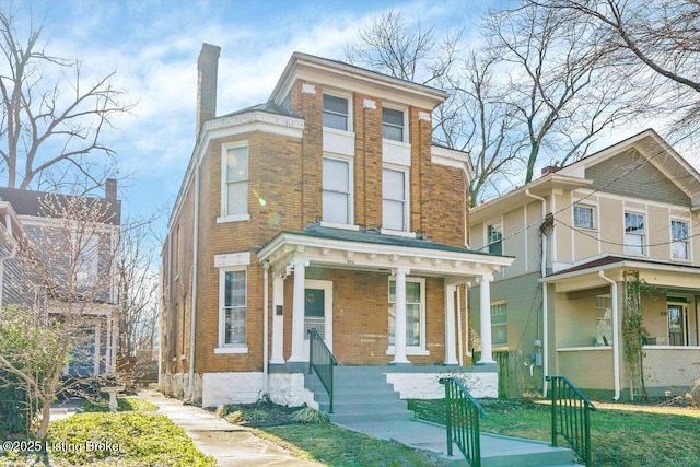 view of front of house with brick siding and a porch