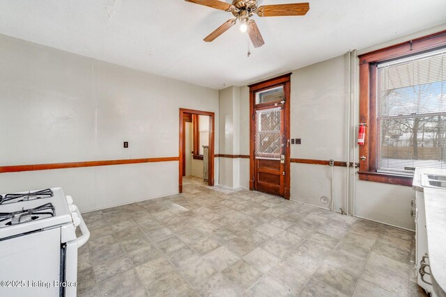 unfurnished room with a ceiling fan