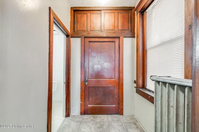 doorway to outside with radiator heating unit