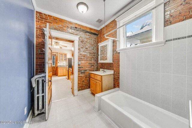 bathroom featuring tile patterned floors, visible vents, and brick wall