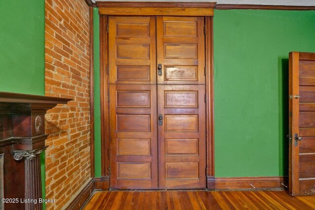 doorway to property featuring brick siding