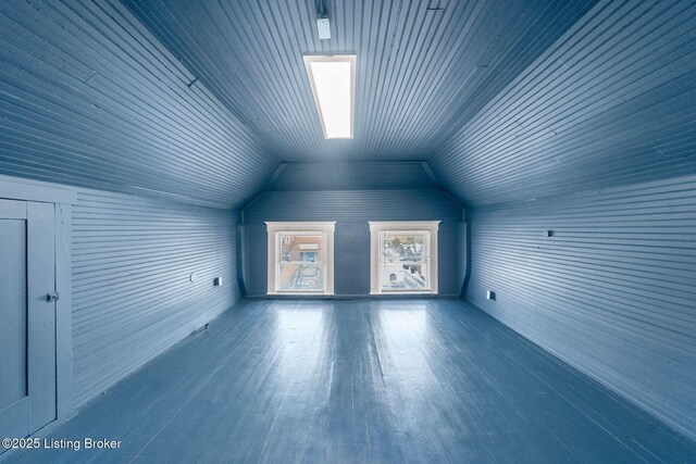 bonus room with lofted ceiling and wood finished floors