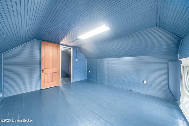 bonus room with lofted ceiling and wood finished floors