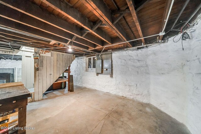 unfinished basement featuring electric panel