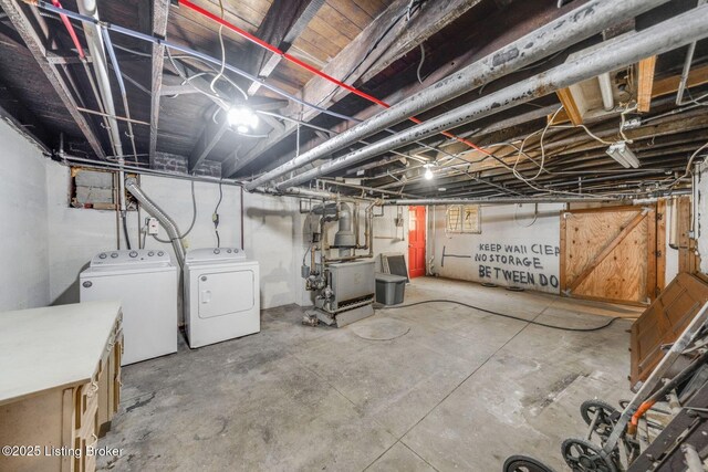 unfinished basement with a heating unit and washing machine and clothes dryer