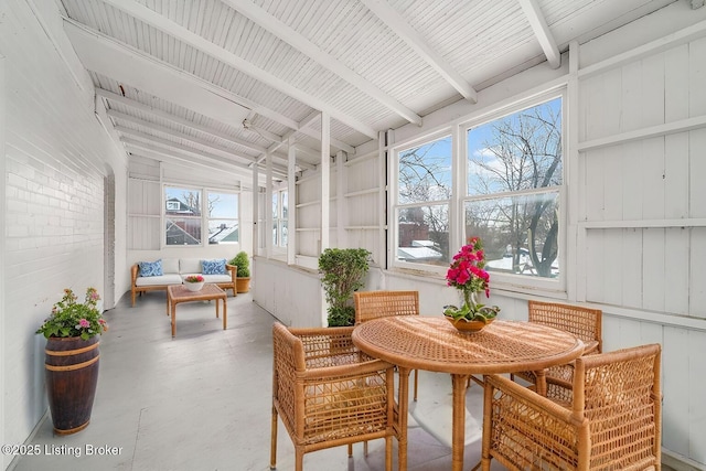 sunroom / solarium featuring a wealth of natural light and lofted ceiling