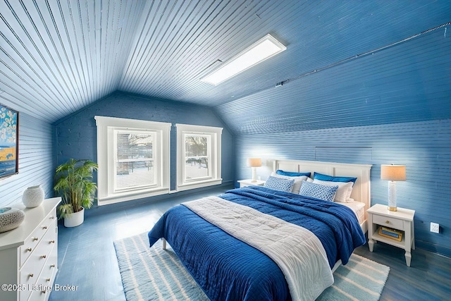 bedroom with wood finished floors and vaulted ceiling