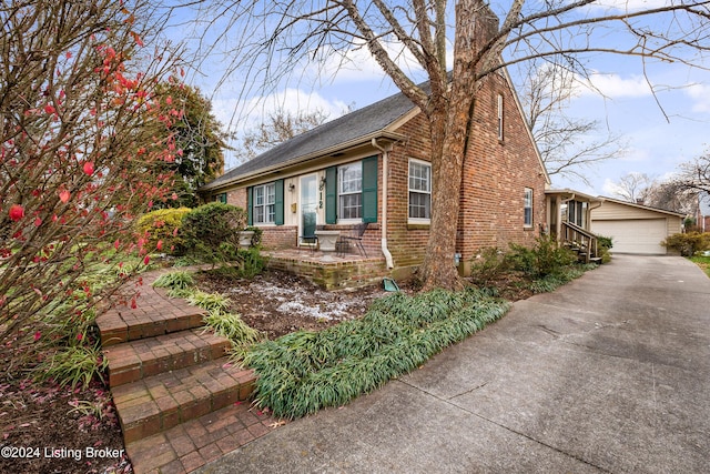 view of front of property featuring a garage and an outdoor structure