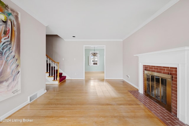 unfurnished living room featuring hardwood / wood-style flooring, crown molding, and a fireplace