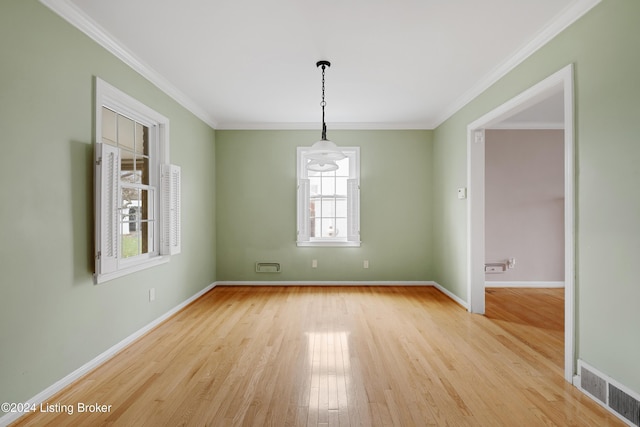 spare room with crown molding and light hardwood / wood-style flooring