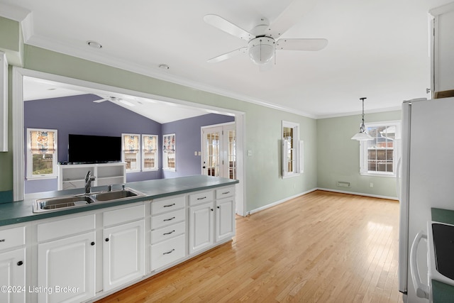 kitchen featuring decorative light fixtures, white cabinetry, sink, white fridge, and ceiling fan