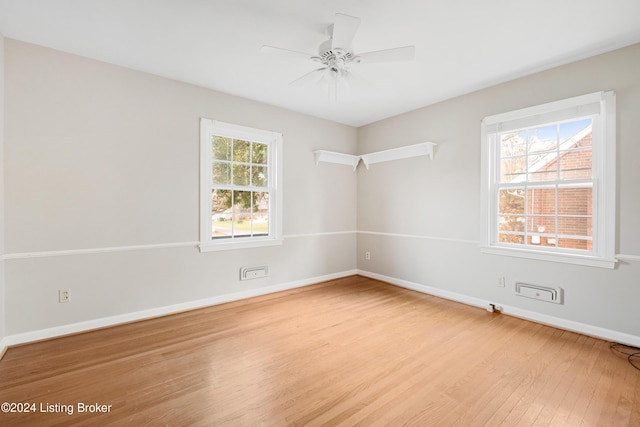 empty room with ceiling fan and light wood-type flooring