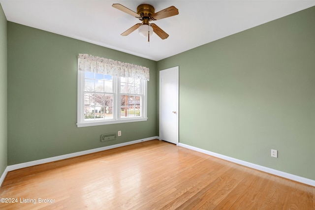 empty room with ceiling fan and light hardwood / wood-style floors