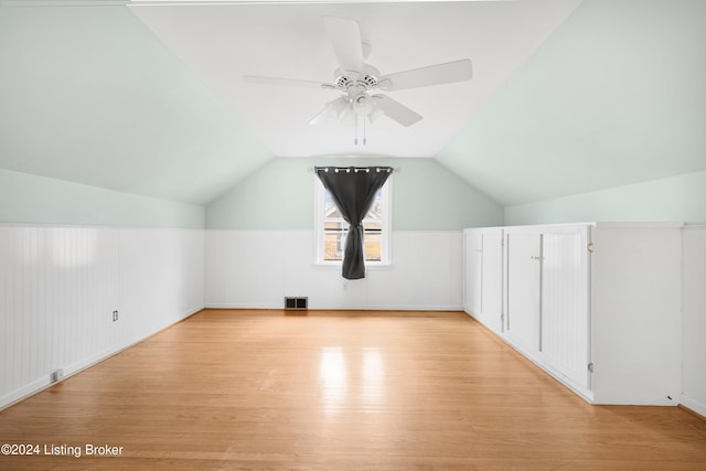 additional living space featuring lofted ceiling, light hardwood / wood-style flooring, and ceiling fan