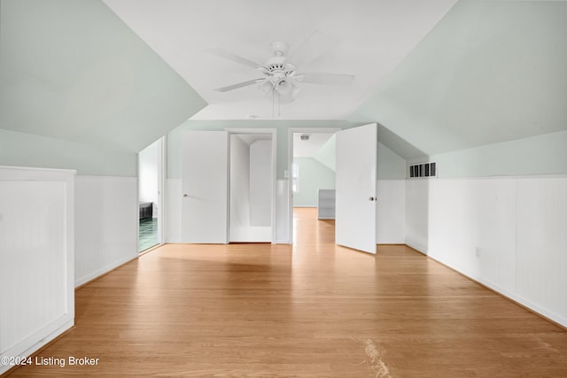 additional living space featuring lofted ceiling, ceiling fan, and light hardwood / wood-style flooring