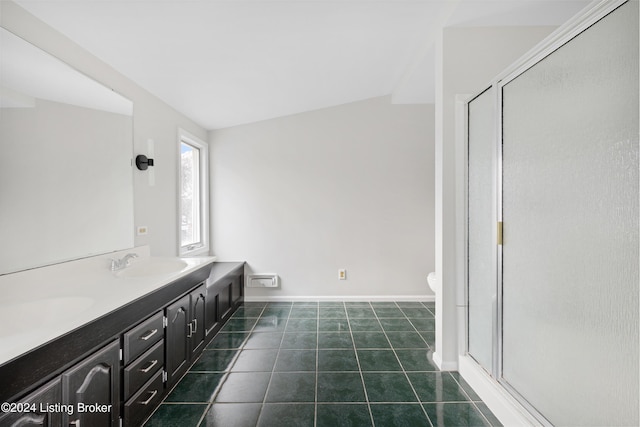 bathroom with toilet, vanity, a shower with door, and tile patterned flooring