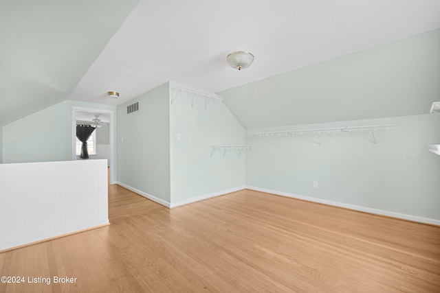 bonus room featuring lofted ceiling and light hardwood / wood-style floors