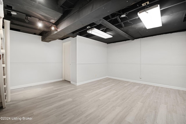 basement with light hardwood / wood-style floors