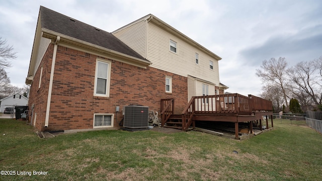 rear view of house featuring a yard, cooling unit, and a deck