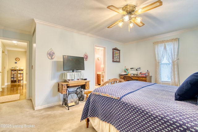 bedroom featuring crown molding, light colored carpet, ceiling fan, and ensuite bathroom