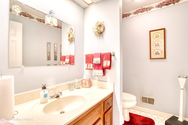 bathroom featuring vanity and toilet