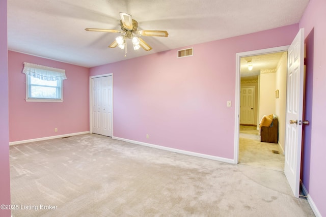 empty room featuring light carpet and ceiling fan