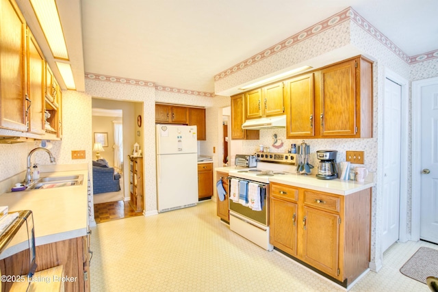 kitchen featuring white appliances and sink