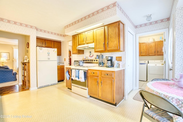 kitchen with independent washer and dryer and white appliances