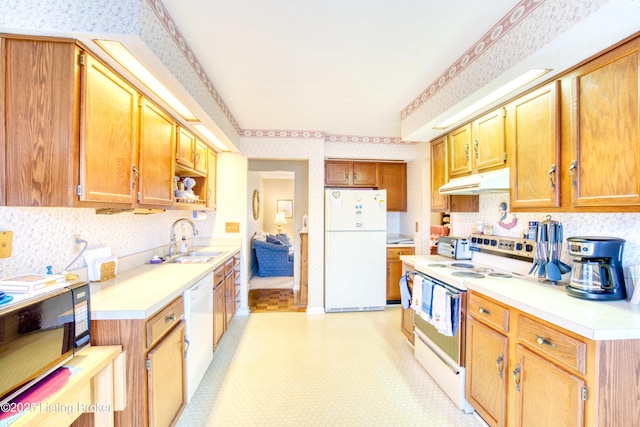 kitchen with sink, white appliances, and decorative backsplash