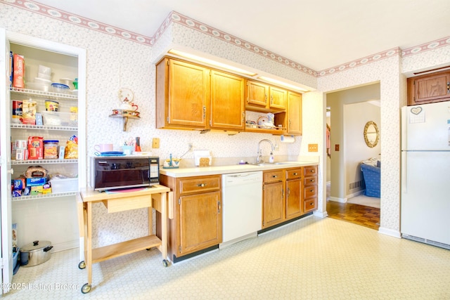 kitchen with white appliances and sink