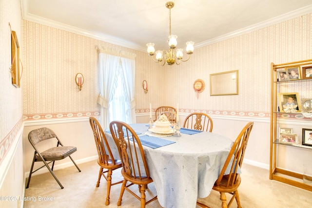 dining space featuring ornamental molding, a chandelier, and carpet