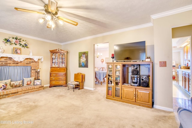 living area with ornamental molding, a brick fireplace, light carpet, and ceiling fan with notable chandelier