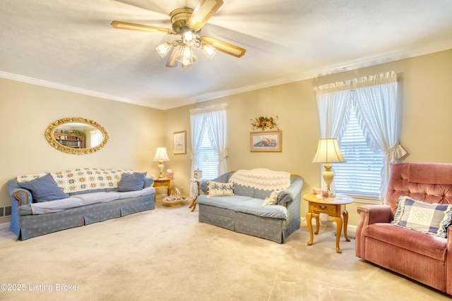 living room featuring ceiling fan, light colored carpet, and ornamental molding