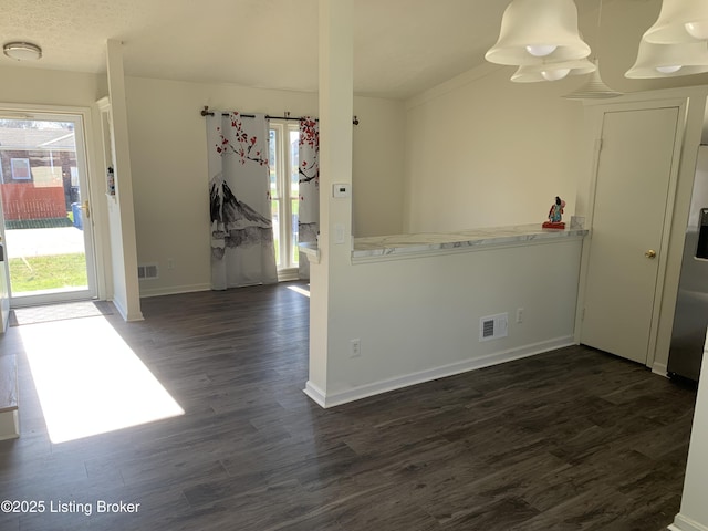 interior space with dark hardwood / wood-style flooring and a textured ceiling