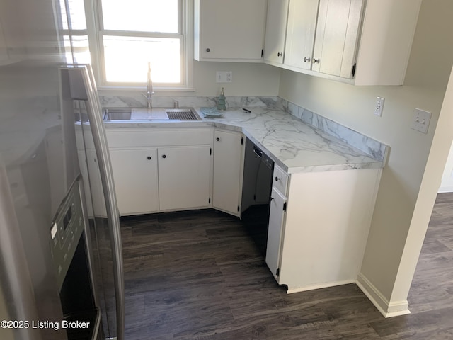 kitchen with stainless steel fridge, dark hardwood / wood-style flooring, sink, and white cabinets