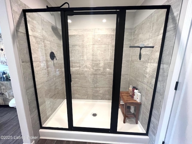 bathroom featuring a shower with door