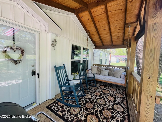 sunroom / solarium featuring beamed ceiling