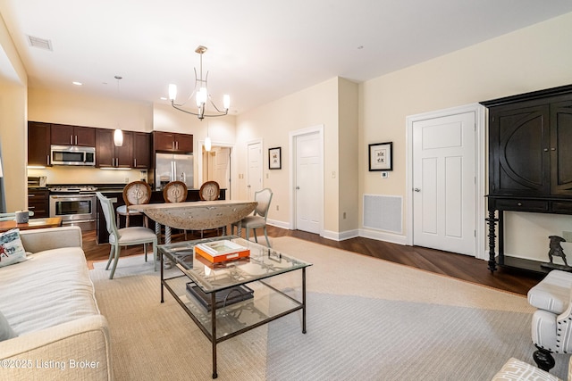 living room with a notable chandelier and light hardwood / wood-style flooring