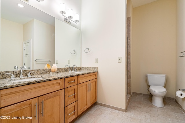 bathroom featuring vanity, tile patterned flooring, toilet, and walk in shower