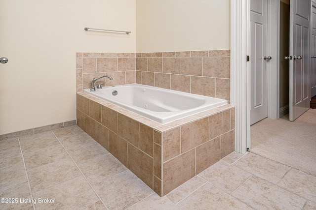 bathroom with tiled bath and tile patterned floors