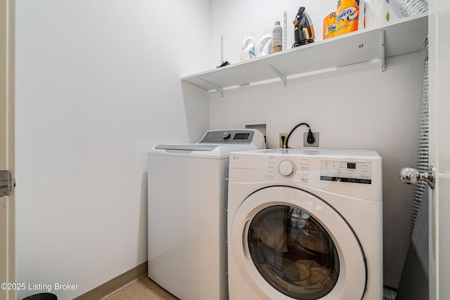 clothes washing area featuring washer and dryer