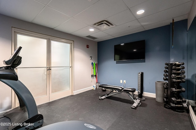 workout room featuring a drop ceiling