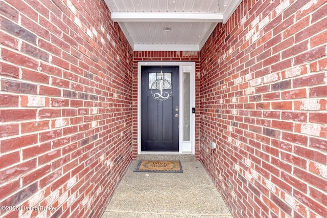 doorway to property with brick siding