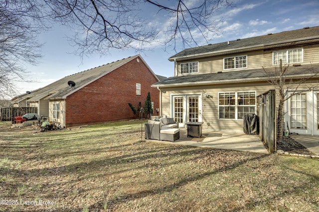 back of house with a yard, an outdoor hangout area, a patio, and french doors