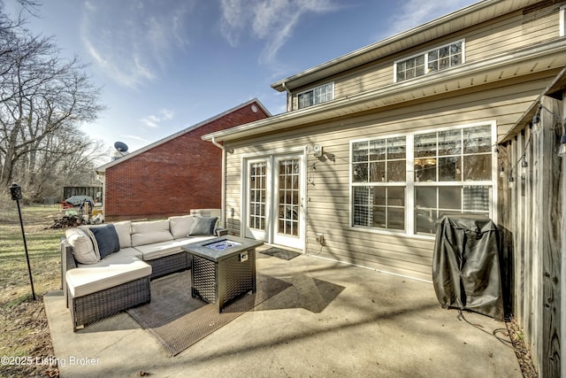 view of patio featuring area for grilling and an outdoor living space with a fire pit