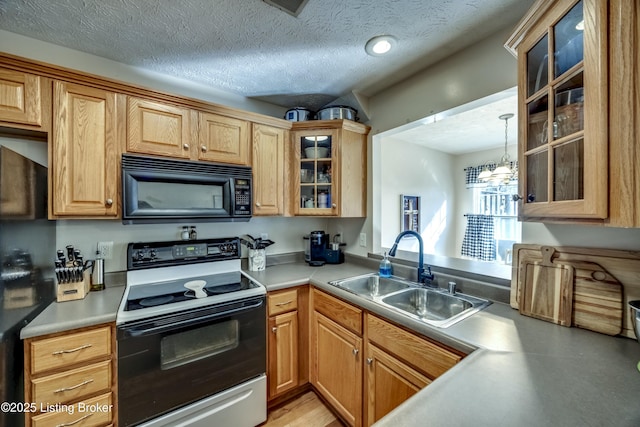 kitchen featuring range with electric cooktop, pendant lighting, sink, a textured ceiling, and an inviting chandelier